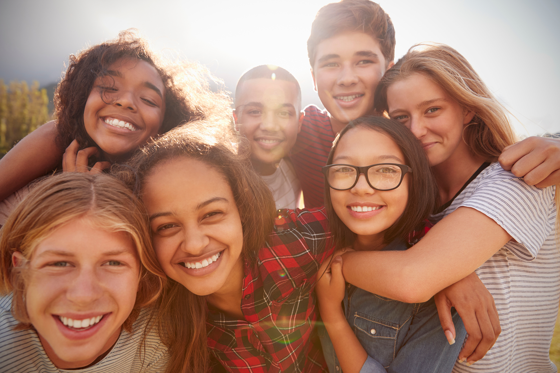 Group of kids having fun together outdoors, representing healthy phone habits and positive screen time.