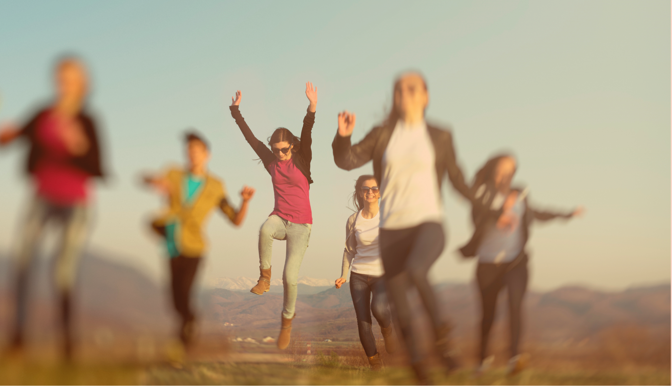 Children jumping outdoors in a playful moment, symbolising confidence and safe independence with their first phone.
